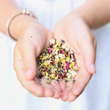 Child holding Snoozy Fox loose tea including chamomile