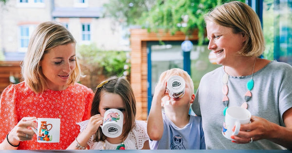 two mums drinking herbal tea with their kids