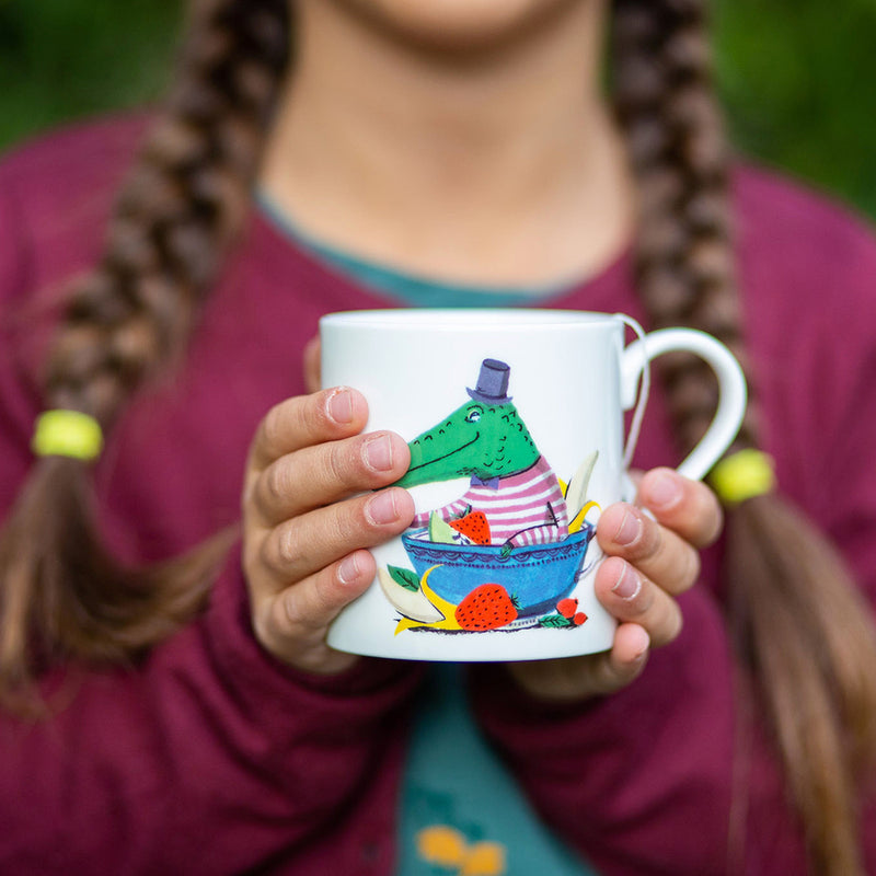 Girl holding mug of Jolly Croc fruit tea
