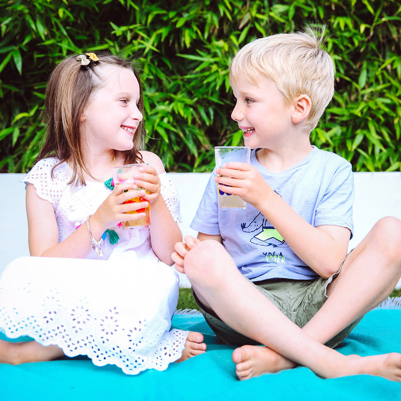 Kids drinking fruit tea over ice in summer