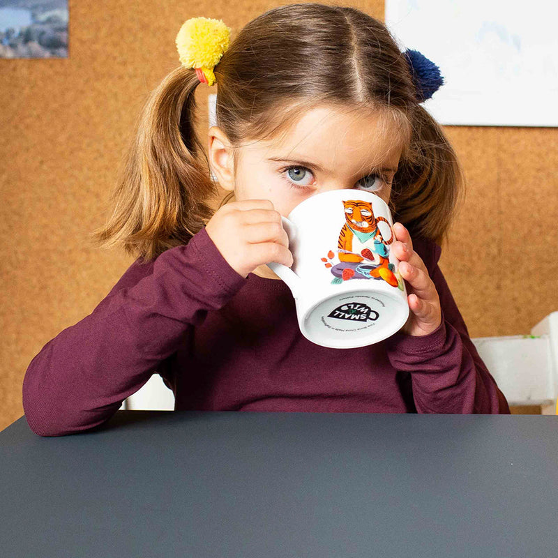 Girl drinking from Merry Tiger mug