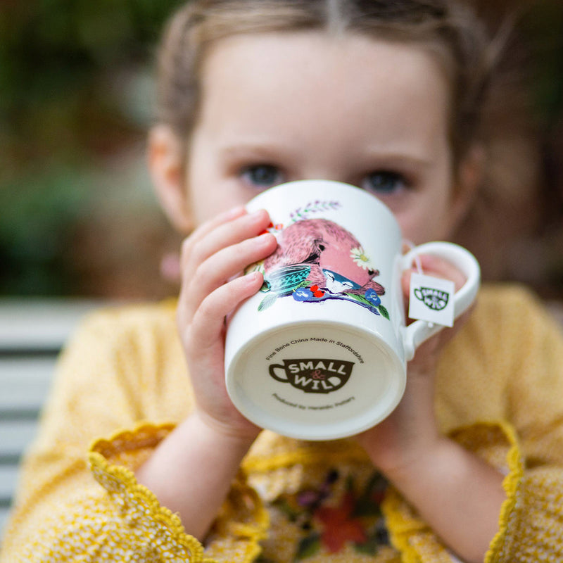 Girl holding fox mug for kids